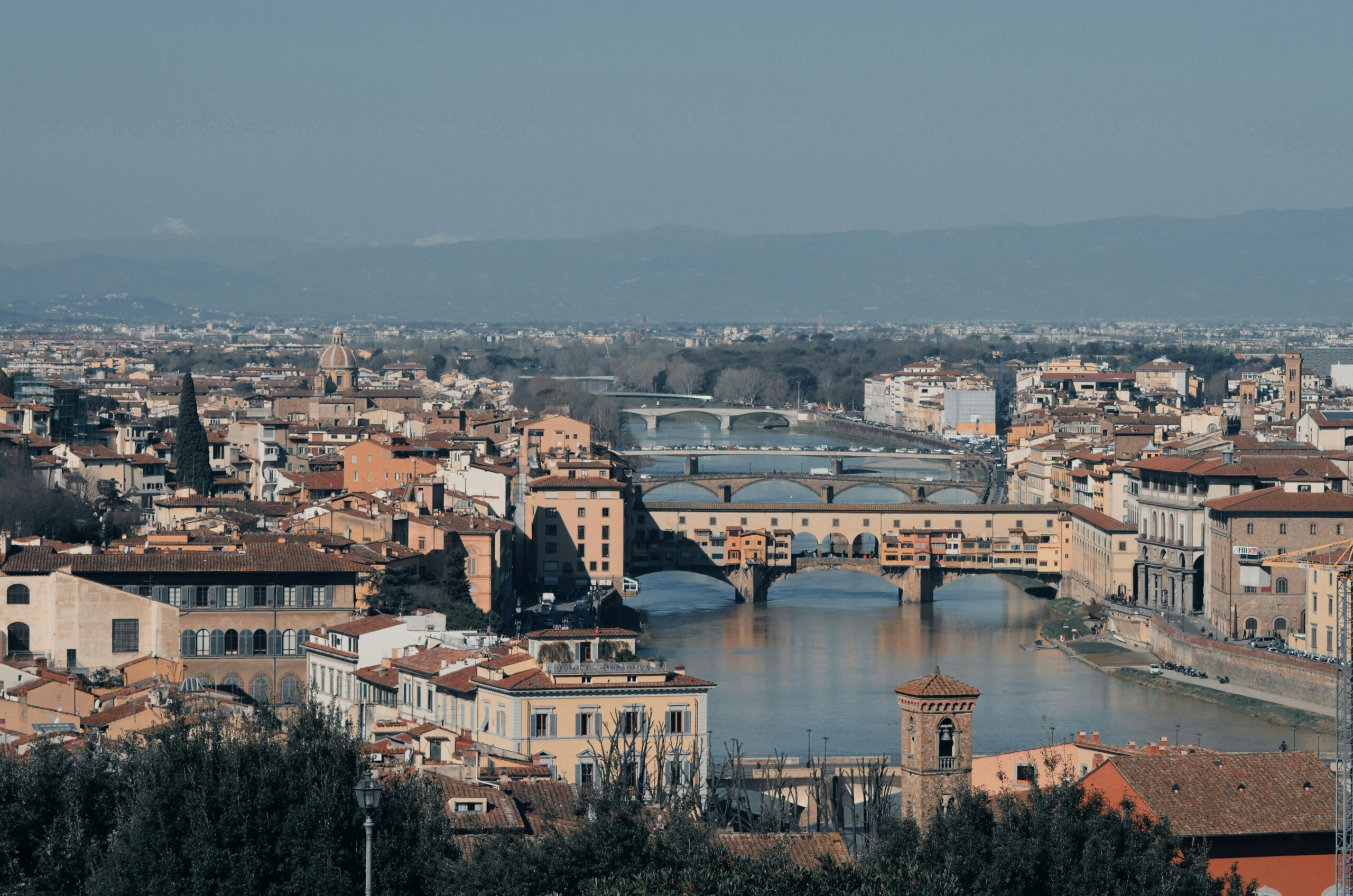 Stunning view of Florence featuring the iconic Ponte Vecchio and Arno River.